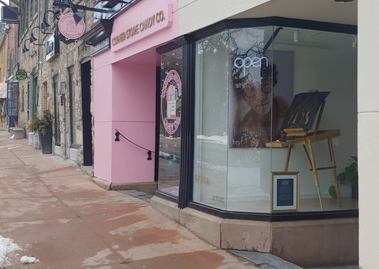 The cream store front of Coles and Keys Inc. in line with other store fronts on York St.